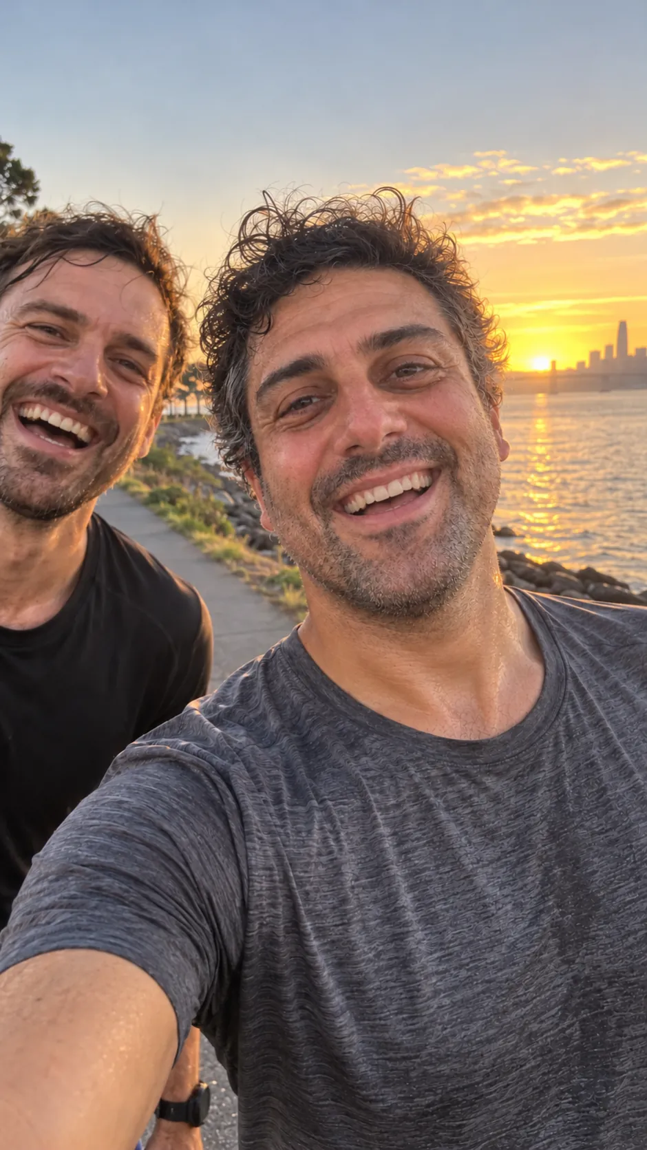 AI-generated example of a future self: a smiling man's selfie by the water at sunset, just after a run.
